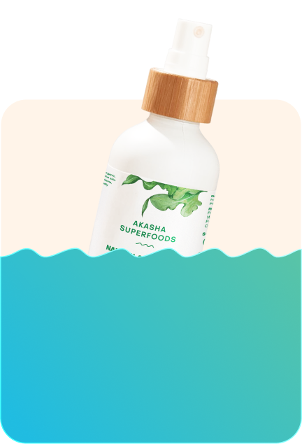 A spray bottle labeled 'Akasha Superfoods' with a wooden cap.