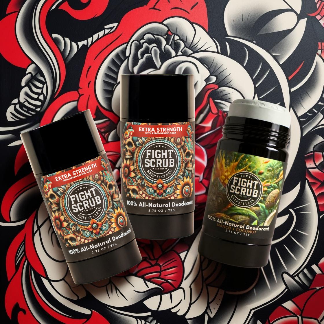 Three Fight Scrub deodorant sticks on a floral and abstract background.