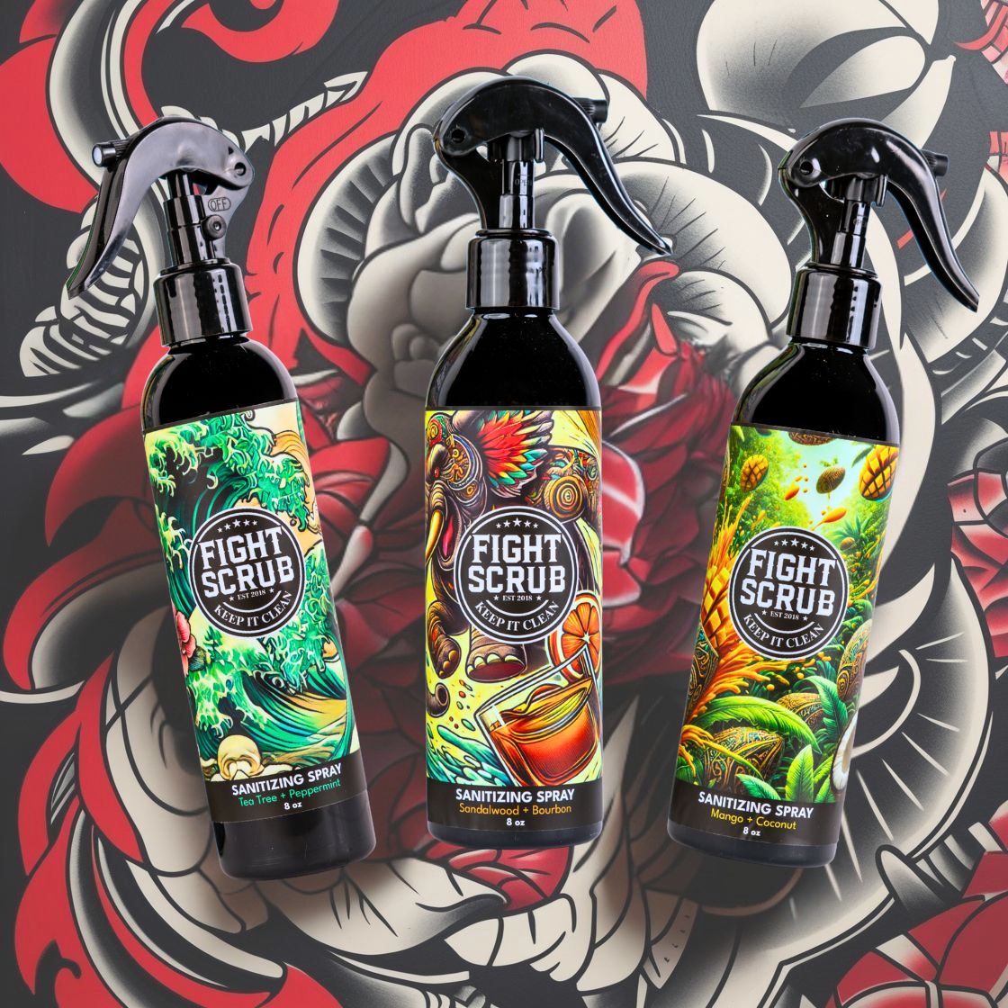Three bottles of Fight Scrub sanitizing spray with colorful labels.