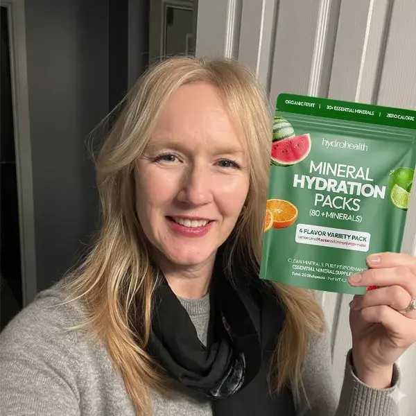 Person holding a pack of mineral hydration supplements.