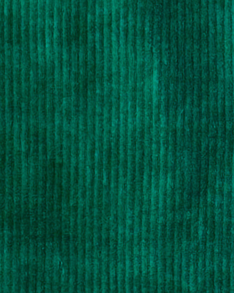 Textured green corduroy fabric with vertical ridges.