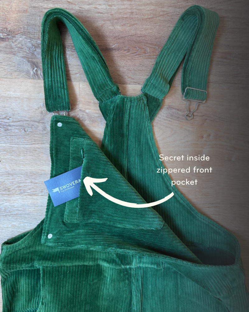 Green corduroy overalls with arrow pointing to a secret zippered front pocket.