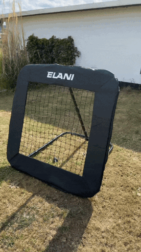 A black sports rebound net with 'ELANI' written on it, set up on grass.