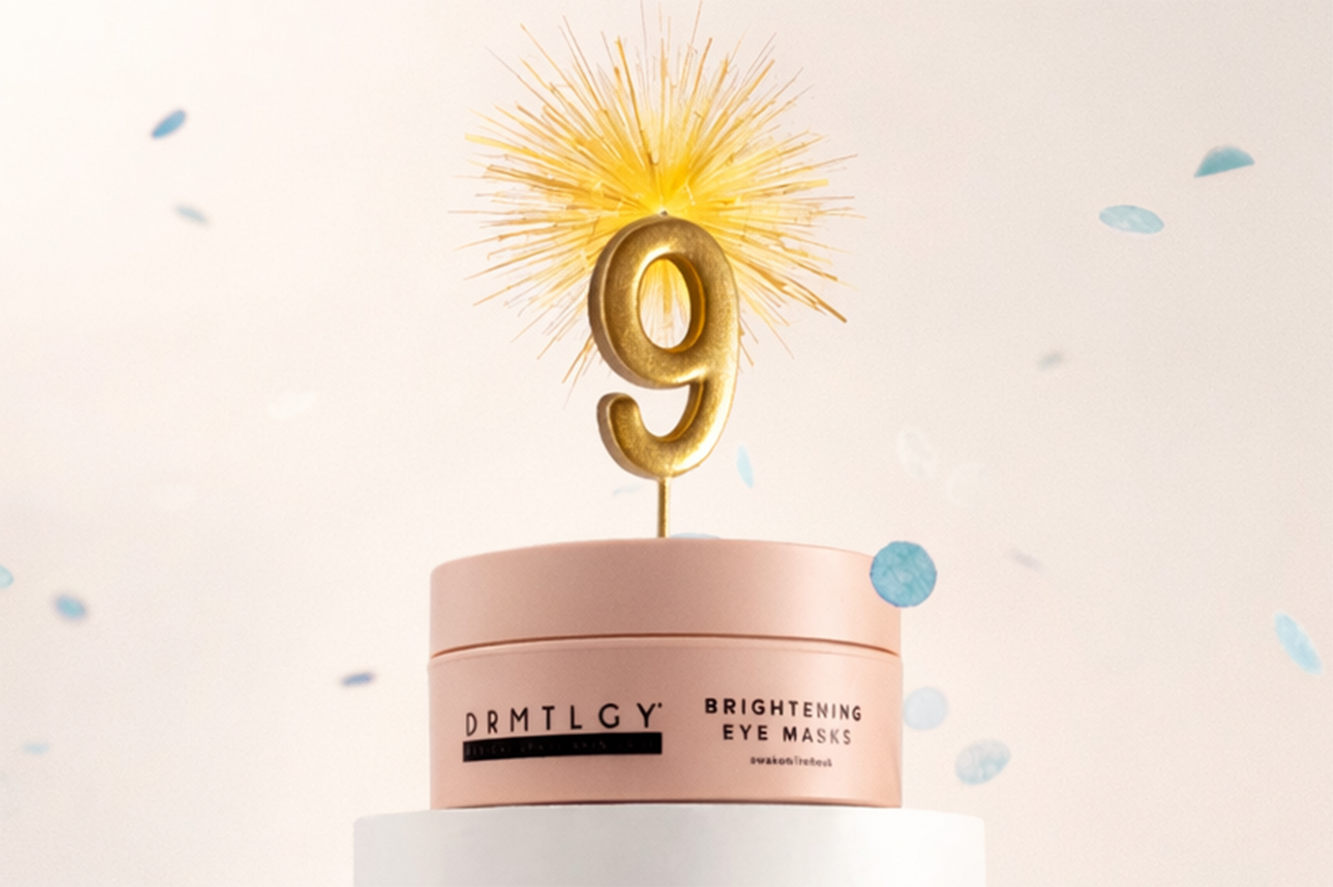A pink jar of DRMTLGY eye masks with a golden number 9 topper and falling blue confetti.