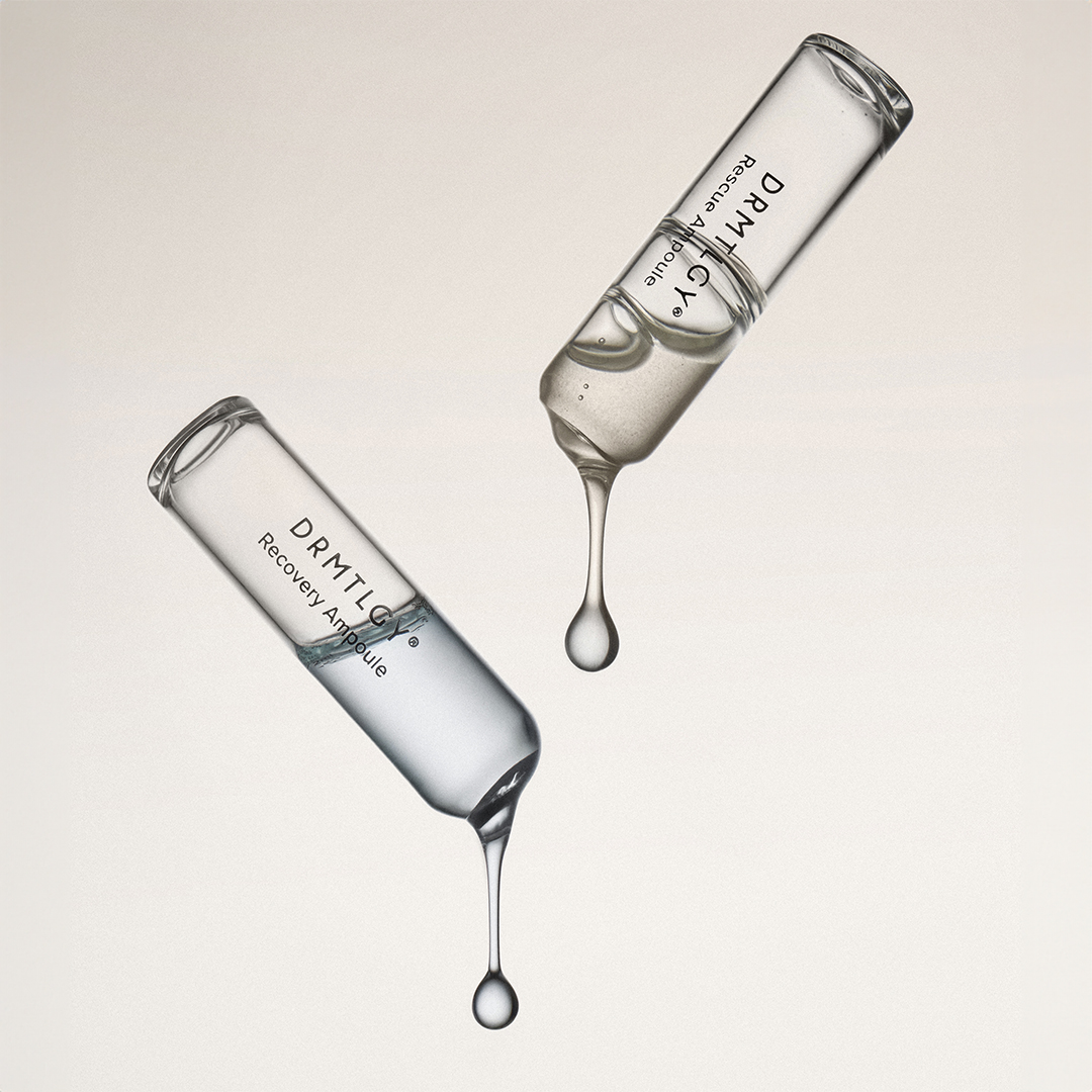 Two DRMTLGY ampoules, a Rescue and a Recovery, with clear liquid dripping from their tips.