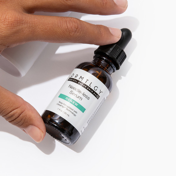 Hand holding a bottle of needle-less serum with a dropper.