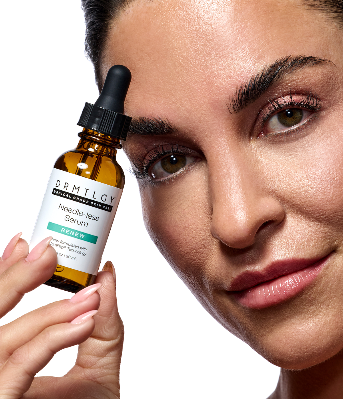 A person holding a Drmtlgy Needle-less Serum bottle near their face.