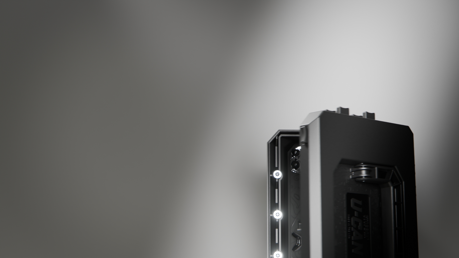 A dramatically lit, close-up shot of a black, rugged electronic device with glowing lights.