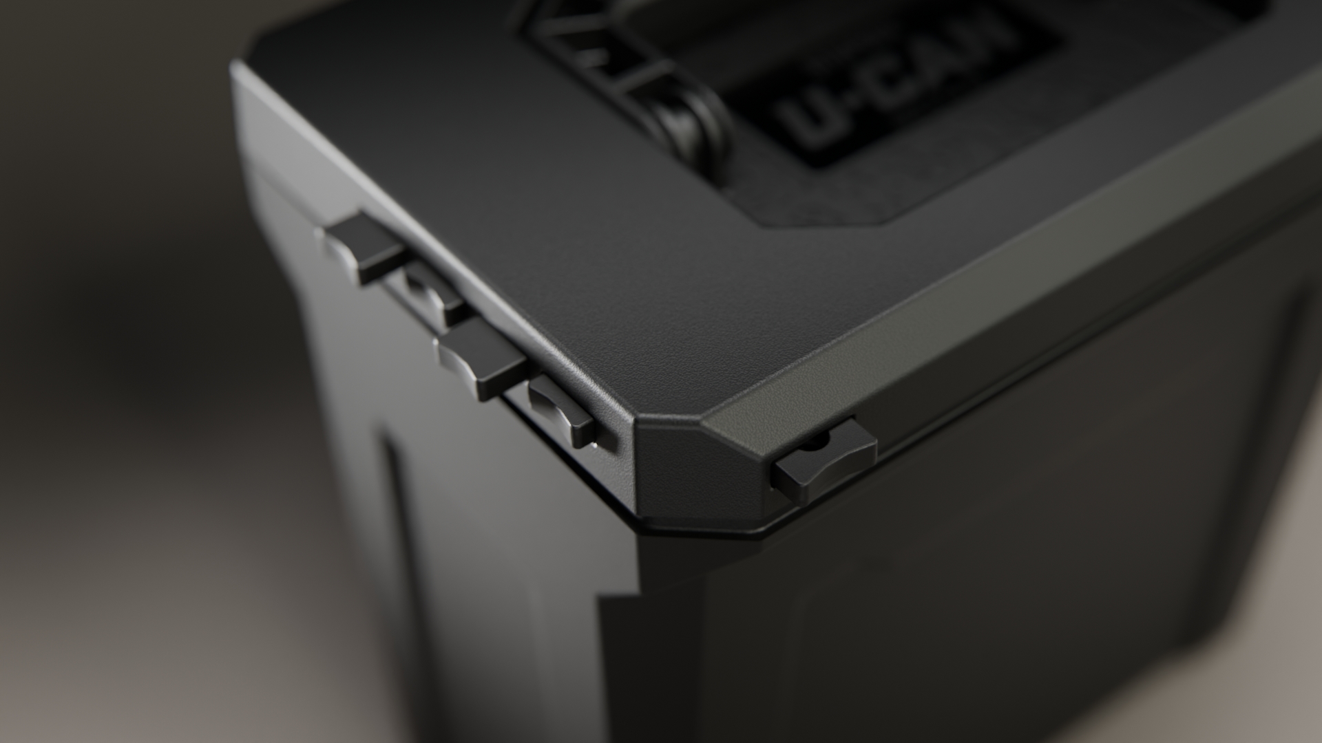 A close-up of the corner of a black, textured U-CAN utility box, showing its interlocking lid.