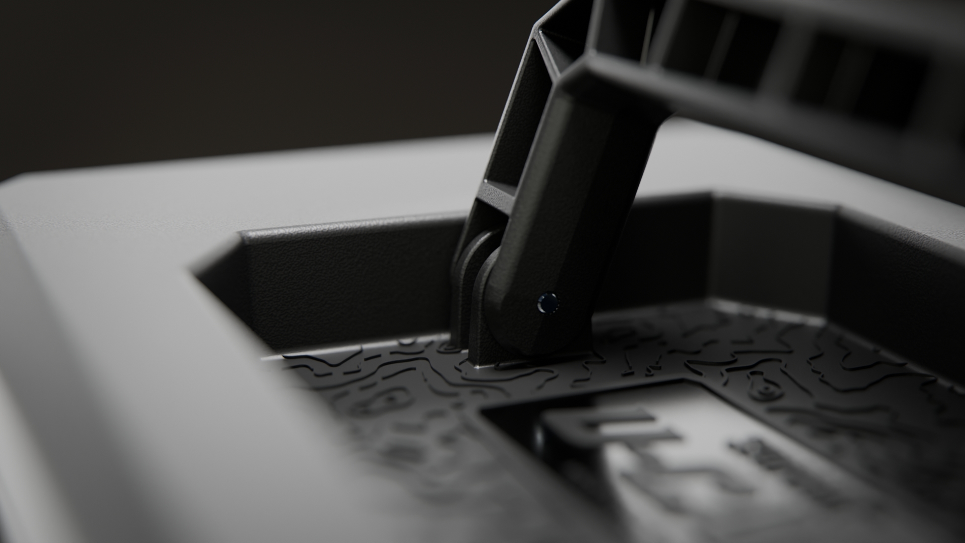 A close-up shot of a black plastic hinge on a textured surface with an embossed topographical pattern.