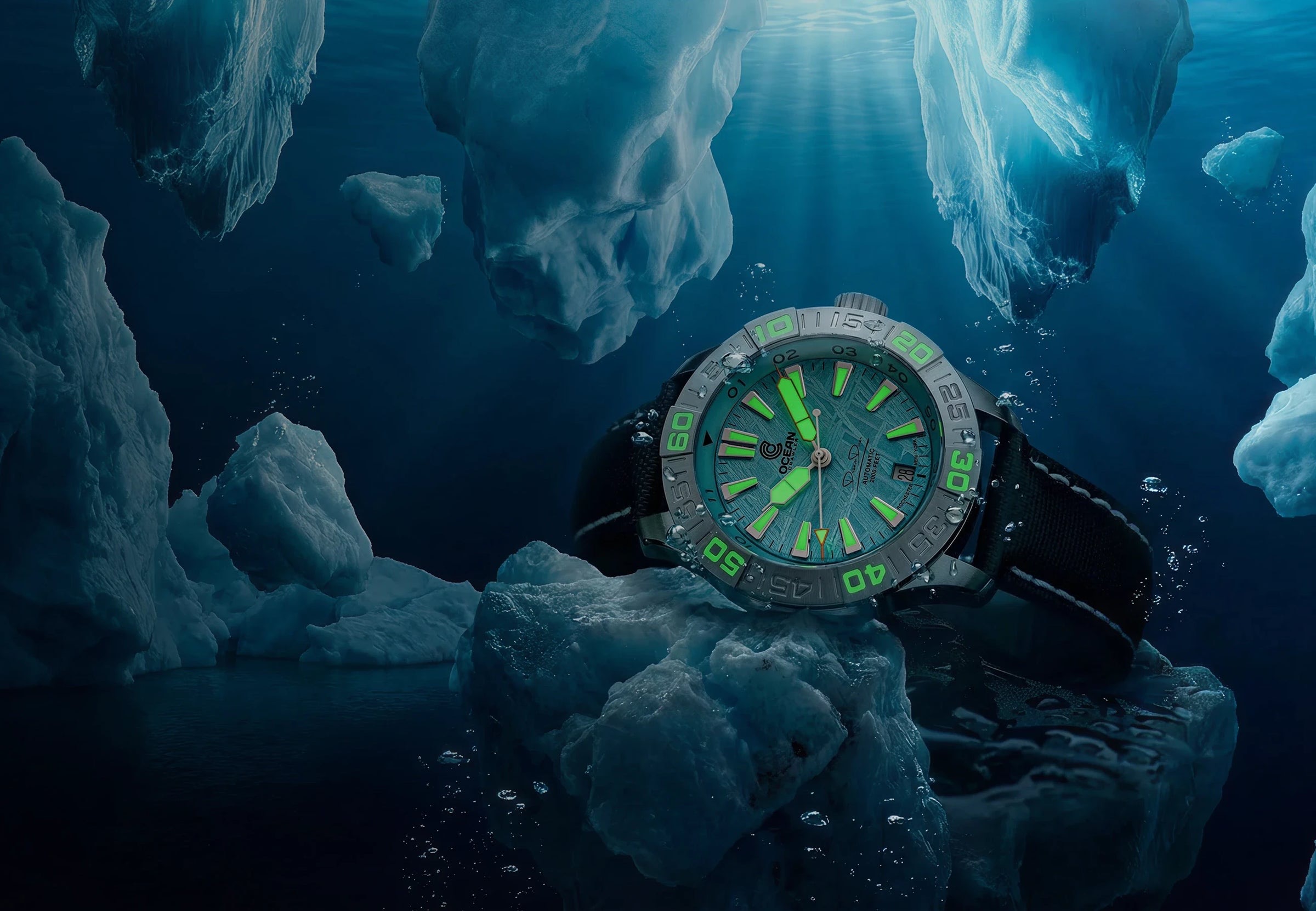 A watch with a luminescent green dial rests on an iceberg in dark, icy water.