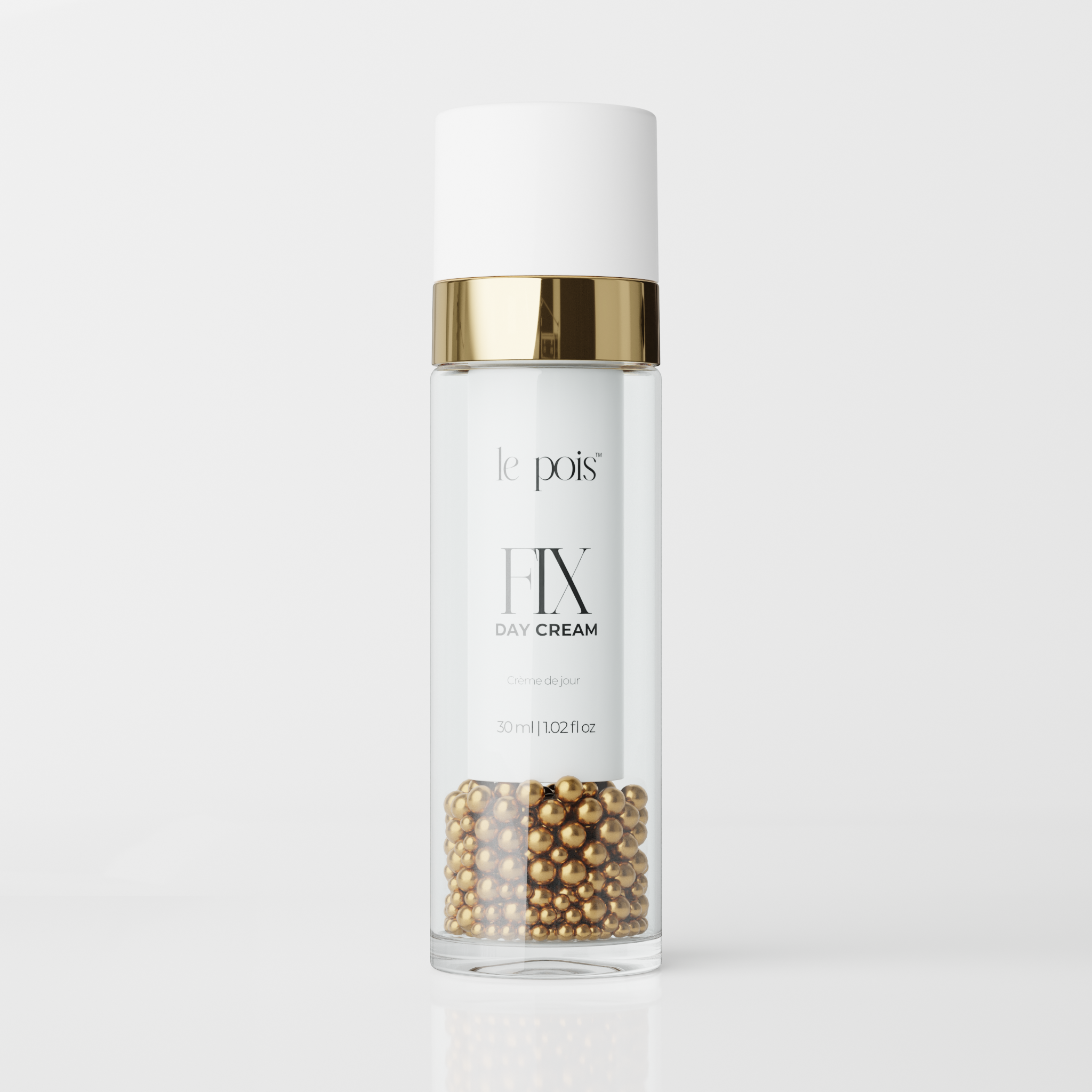 Clear bottle of day cream with gold accents and pearls inside.