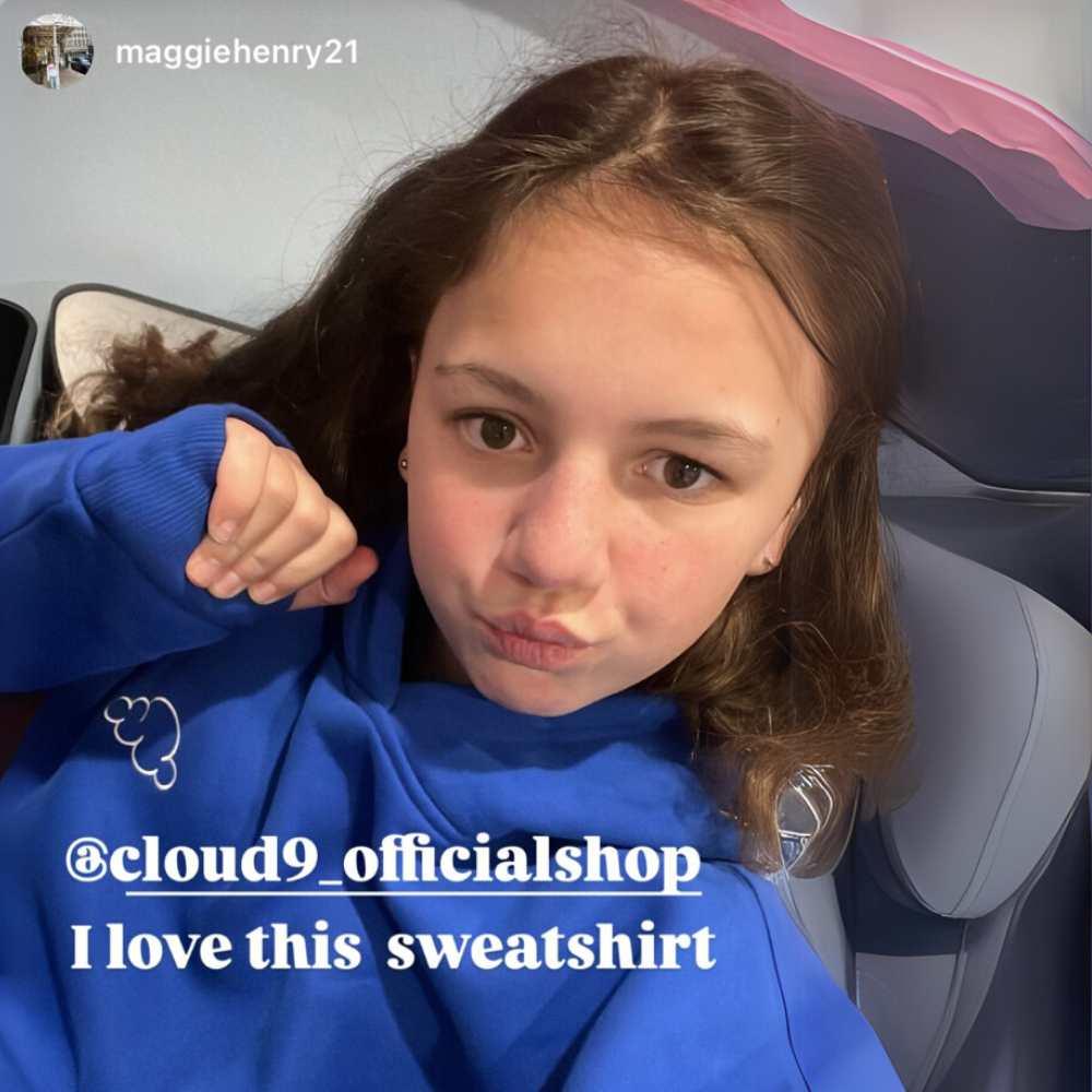 Person in a blue sweatshirt with text overlay about loving the sweatshirt.