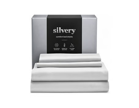 A stack of folded white Silvery comfort bed sheets is shown in front of its packaging box.