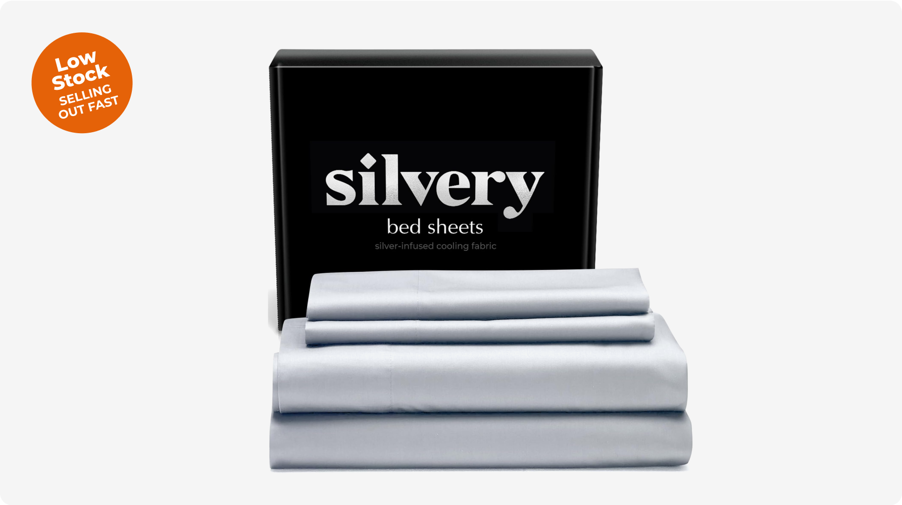 Silvery bed sheets in packaging with 'Low Stock' sticker.