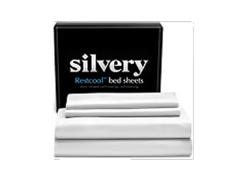 A stack of folded white Silvery Restcool bed sheets in front of their black packaging box.