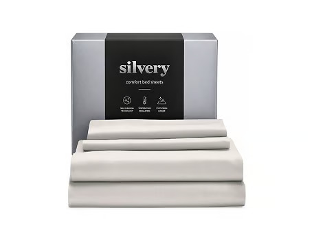 A set of folded, light gray Silvery bed sheets in front of their silver and black packaging.