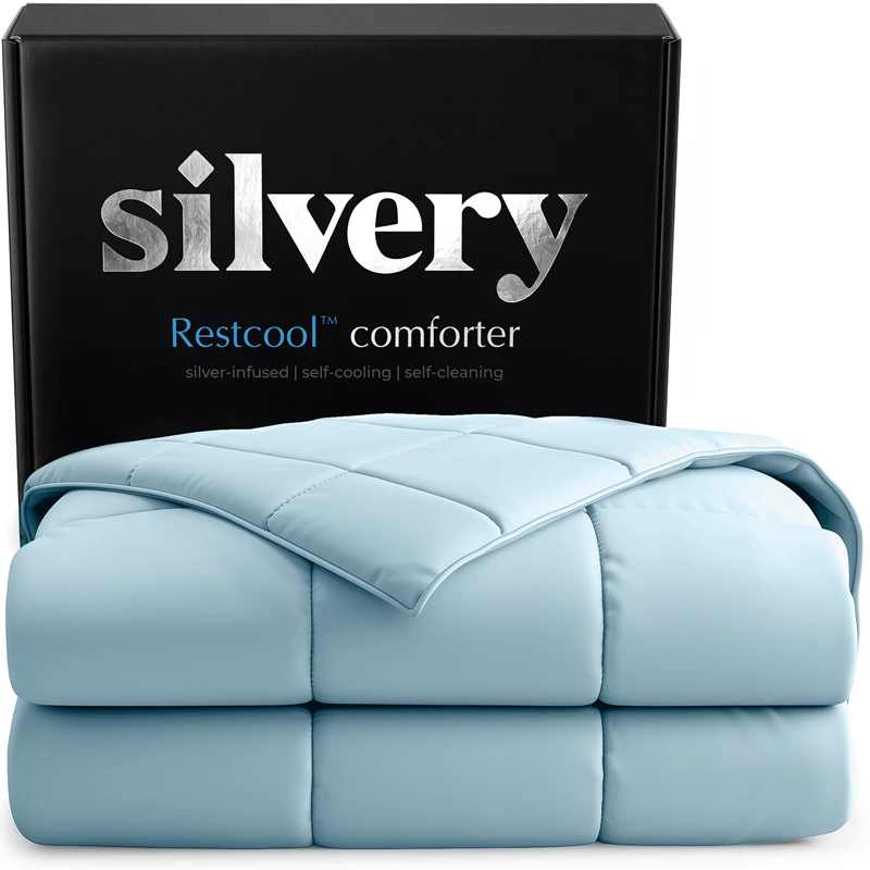 A folded, light blue Restcool comforter by Silvery is shown in front of its black packaging box.