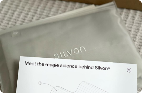 A Silvon product package and an informational sheet on a textured surface.
