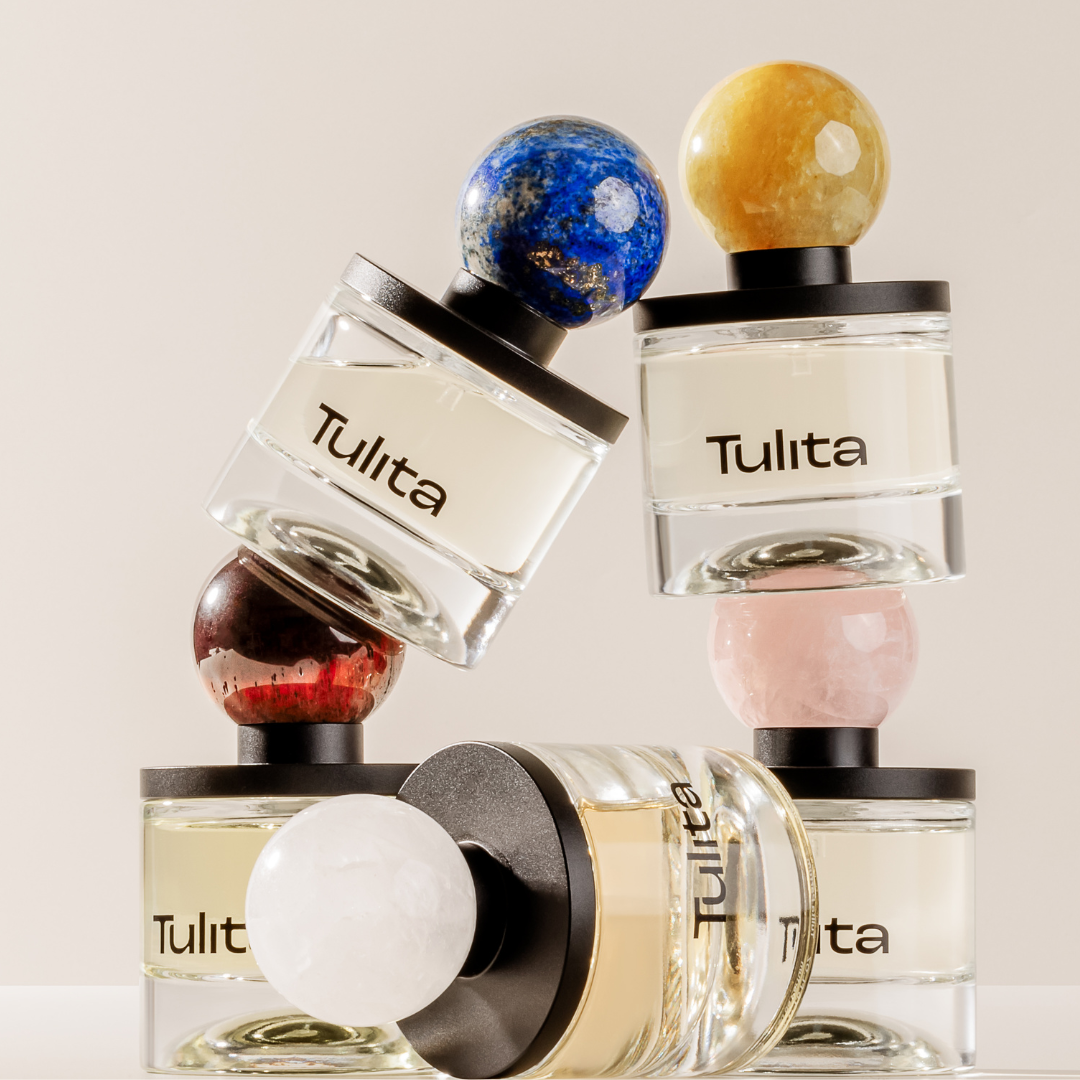 Perfume bottles with colorful spherical caps stacked creatively.