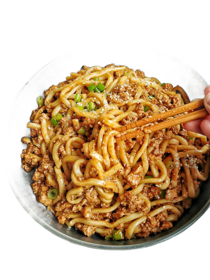 Bowl of noodles with minced meat and green onions, held with chopsticks.