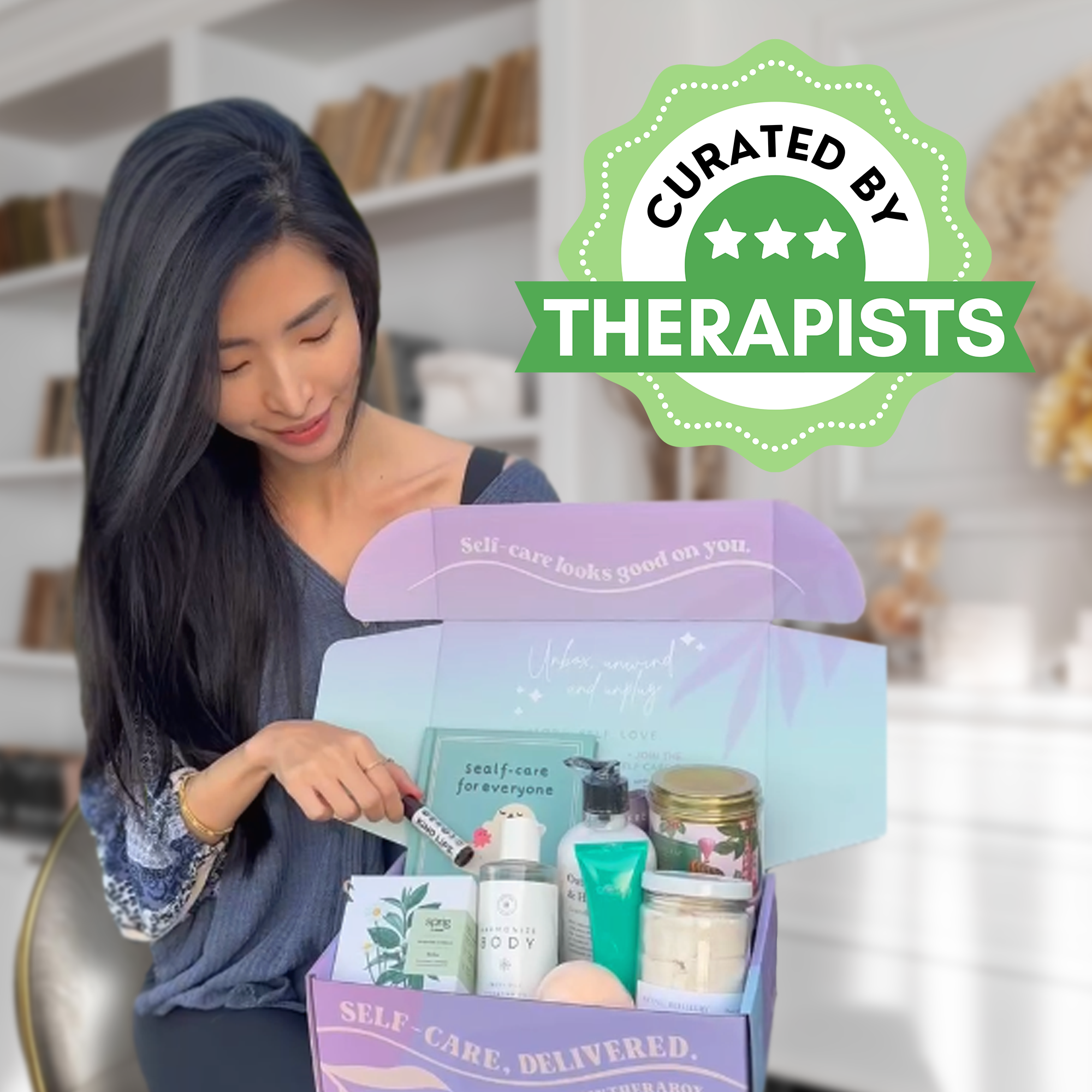 Person opening a self-care package with various products, labeled 'Curated by Therapists.'