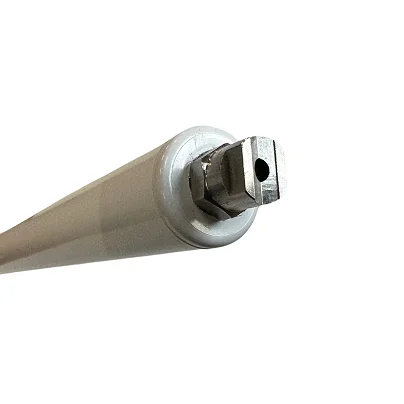 A close-up of the end of a white roller tube with a square metal pin.