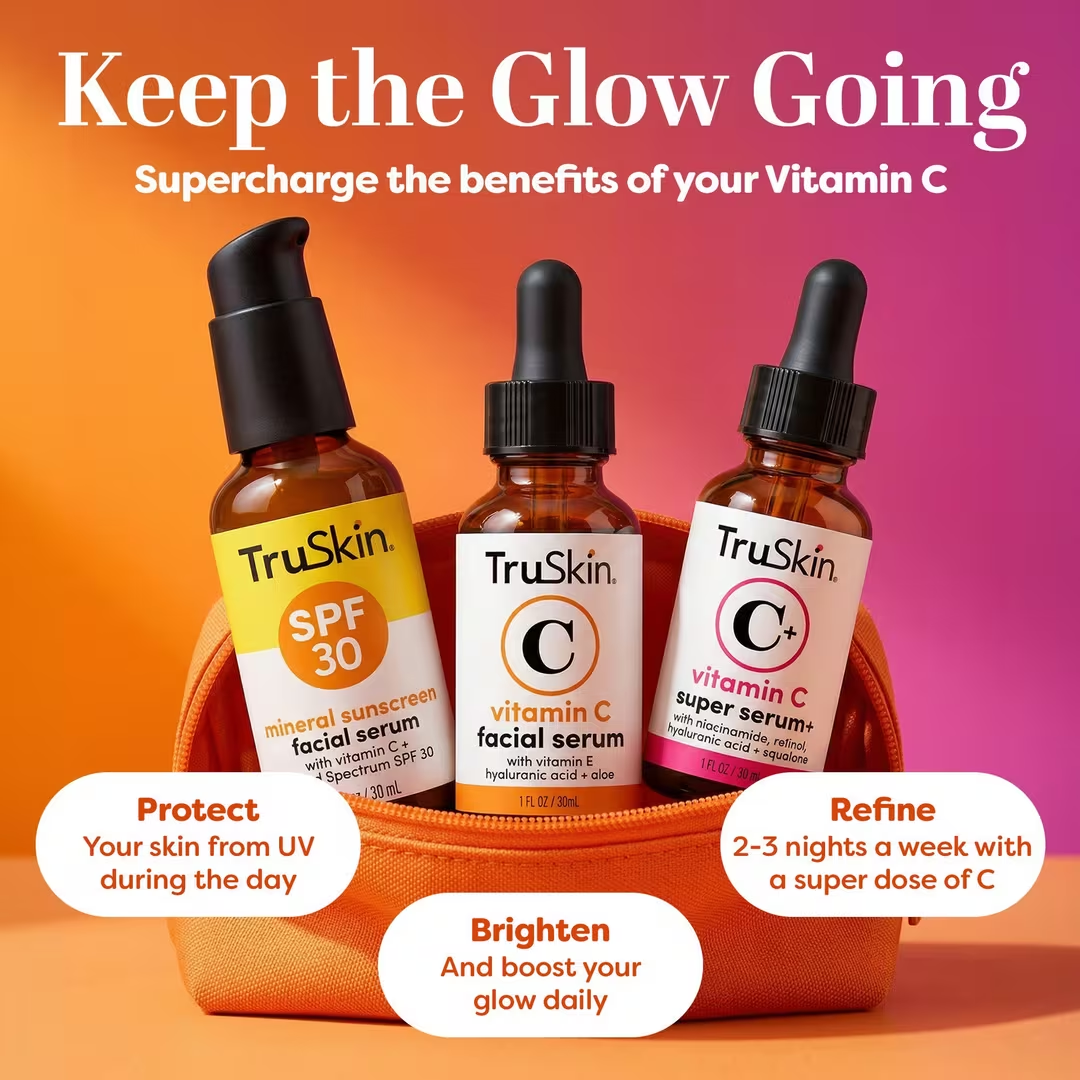 Three bottles of TruSkin skincare serums sit in a small orange bag against a colorful gradient background.
