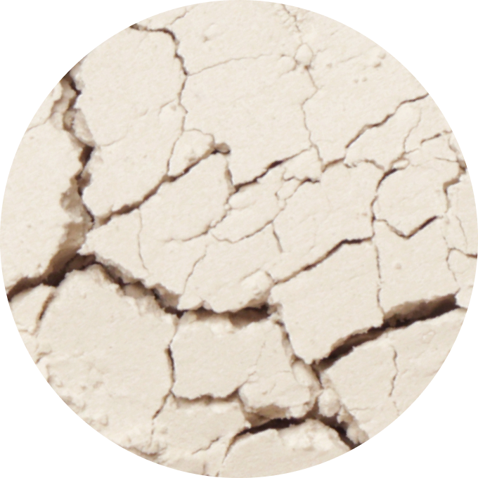 Close-up of cracked, dry, beige surface resembling parched earth.