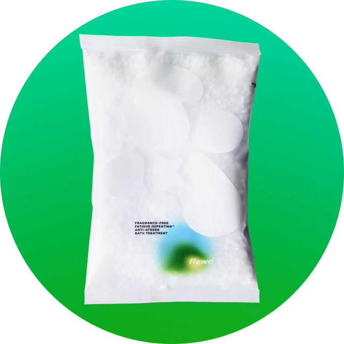 A white pouch of Flewd anti-stress bath treatment against a bright green circular background.