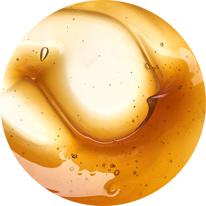 Close-up of a golden liquid with bubbles and swirls.