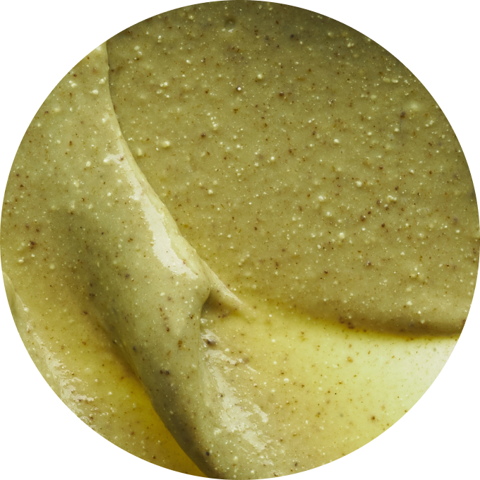 Close-up of a creamy, textured greenish-brown substance.