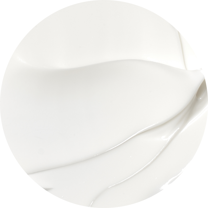 Close-up of smooth, white cream texture in a circular frame.