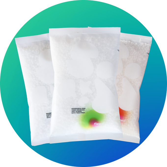 Three semi-transparent white pouches of bath treatment beads against a blue and green circular background.