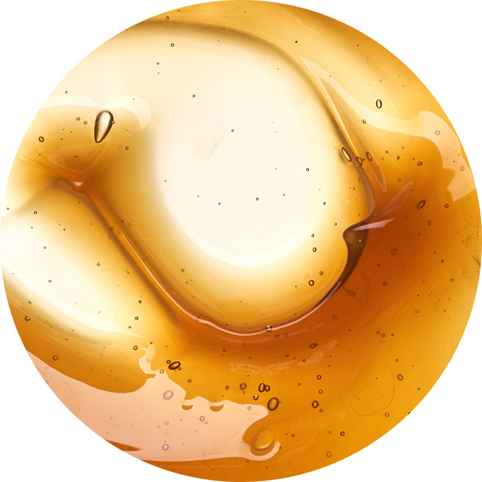 Close-up of a translucent amber liquid with bubbles.