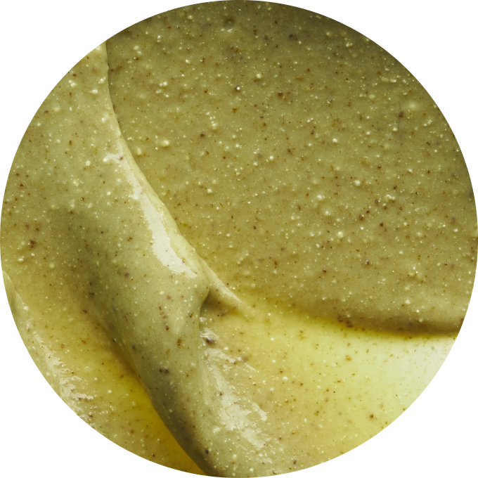 Close-up of a creamy, textured greenish-brown substance.