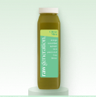 Green juice bottle with label on a light green background.