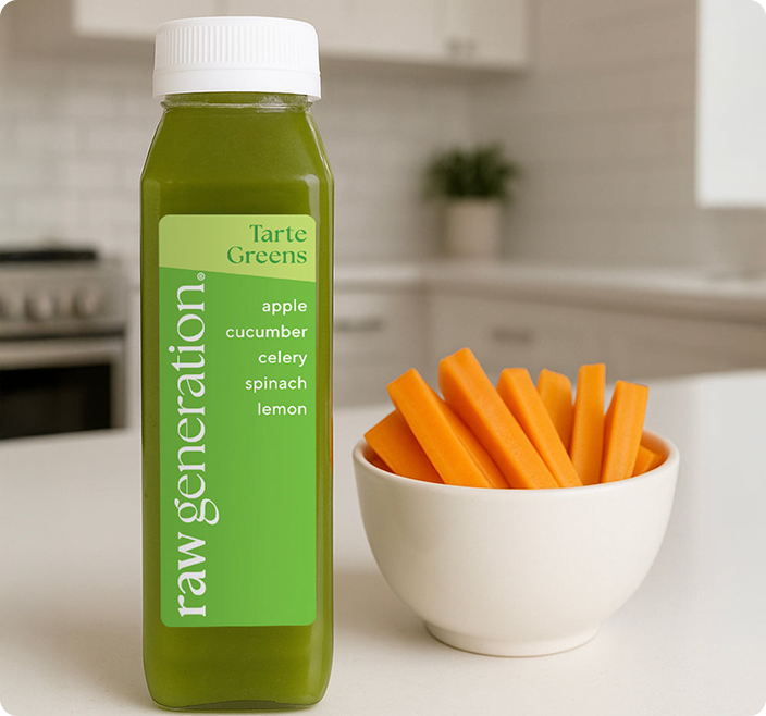 A bottle of green juice from Raw Generation next to a small bowl of carrot sticks.