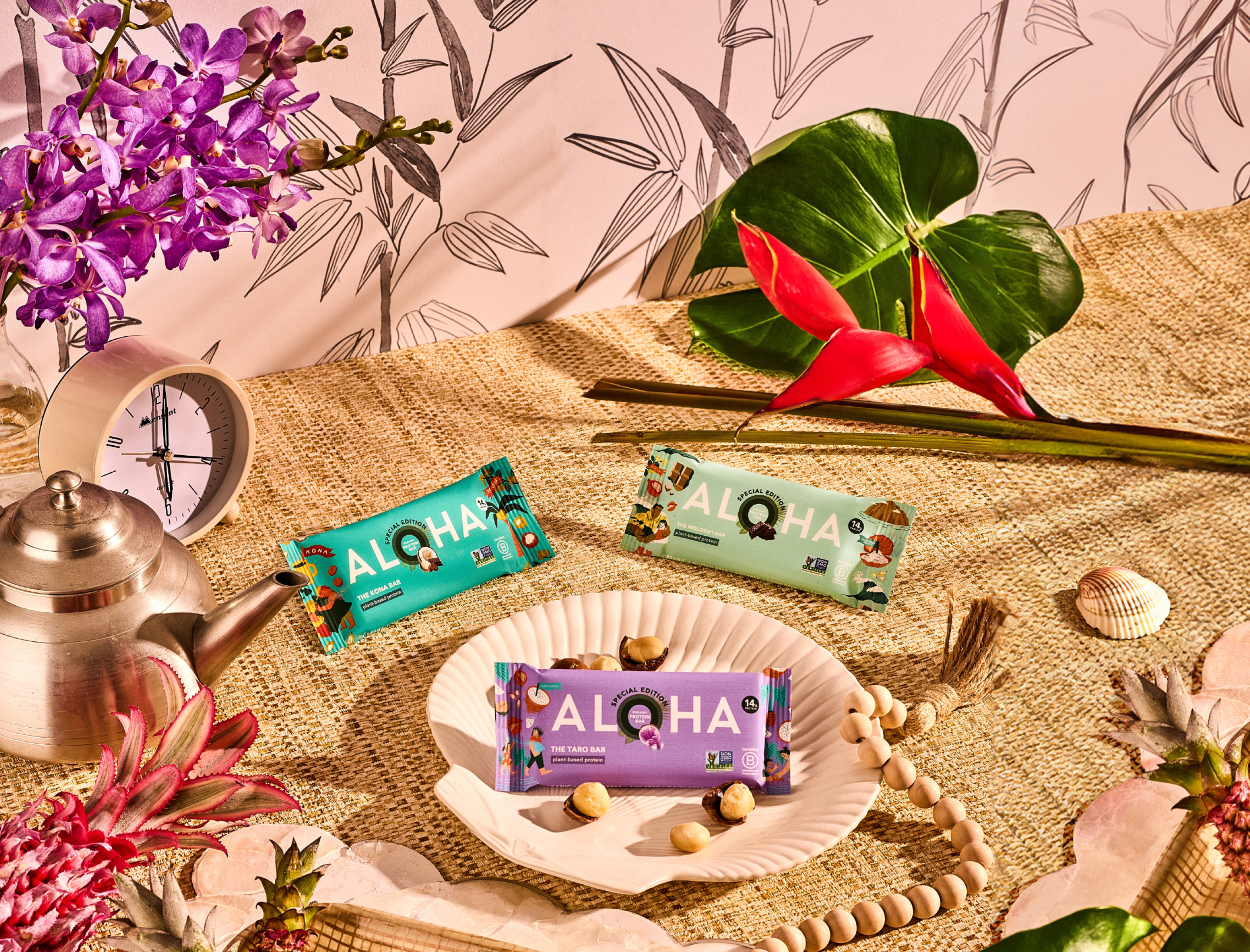Colorful Aloha protein bars displayed with tropical decor.