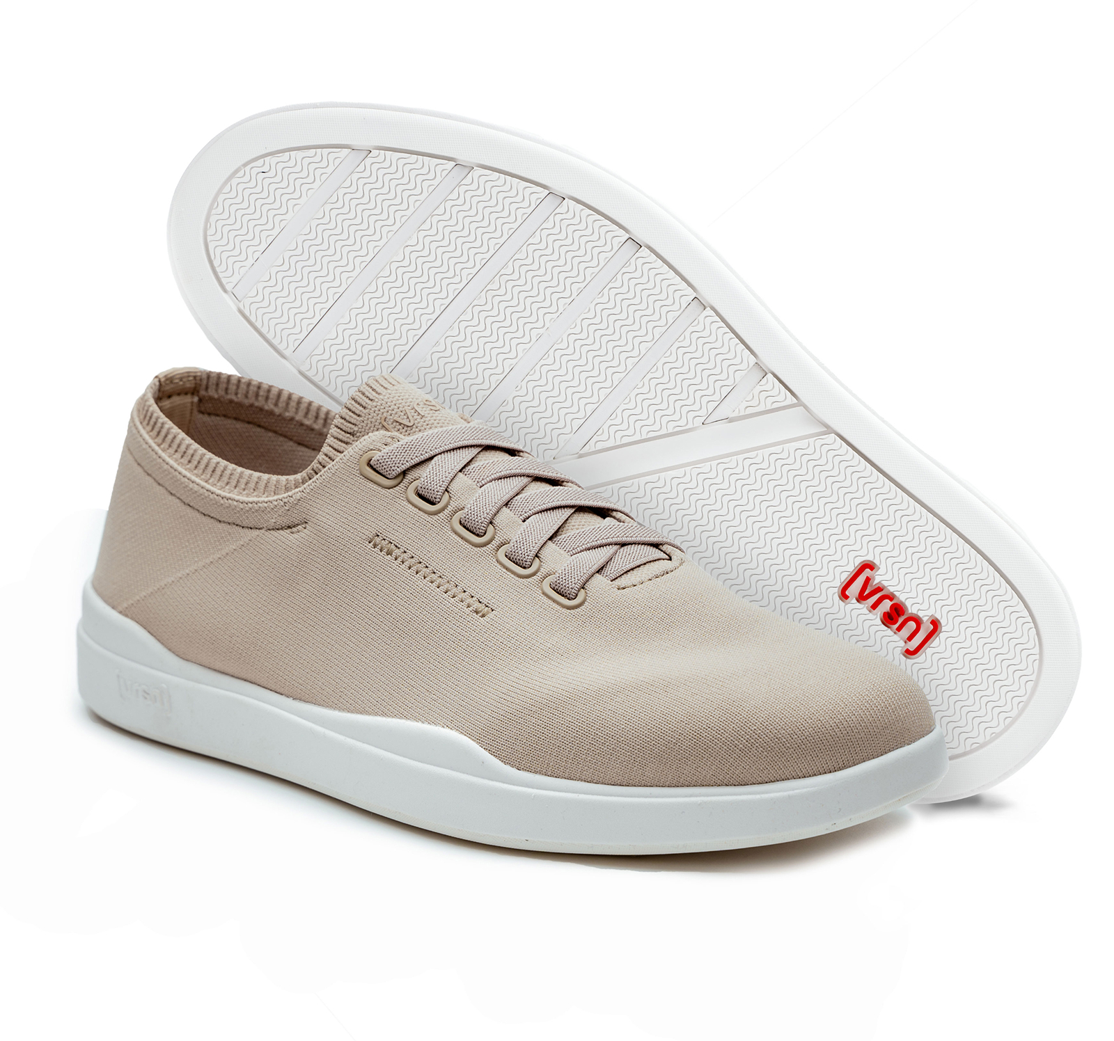 A pair of tan canvas lace-up sneakers with white soles, against a white background.