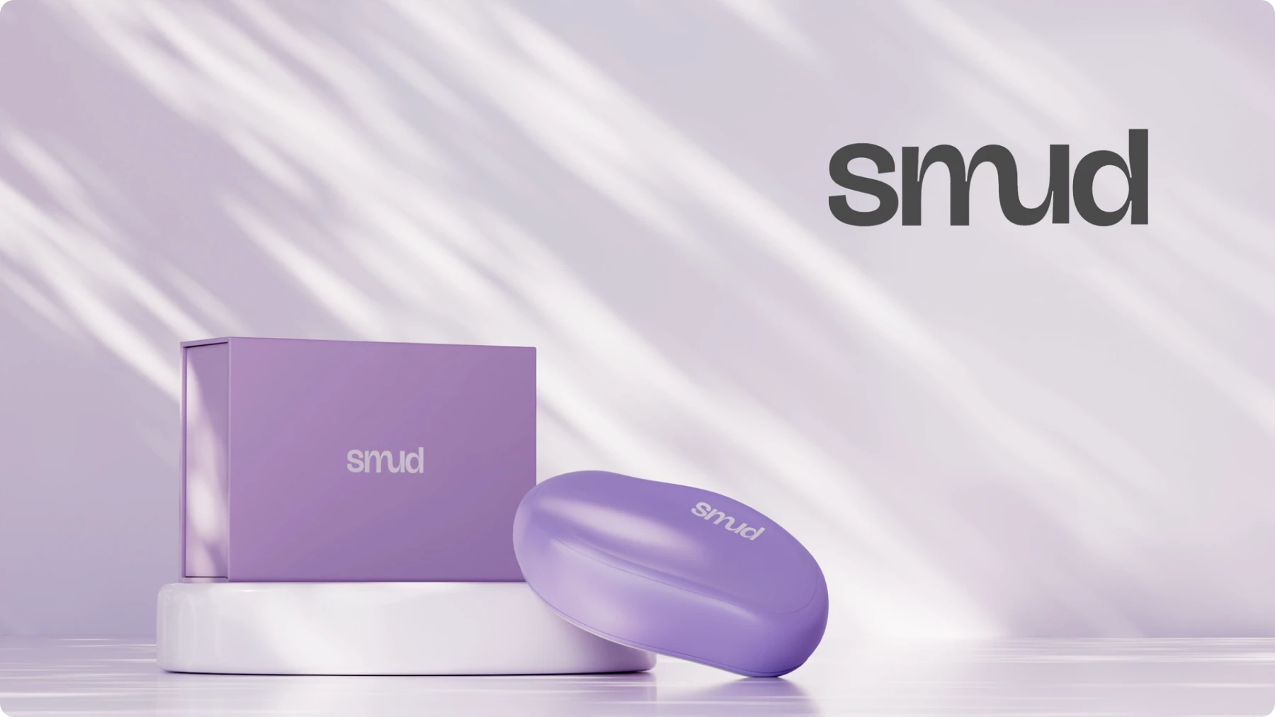 Purple box and soap with 'smud' logo, displayed on a white platform.
