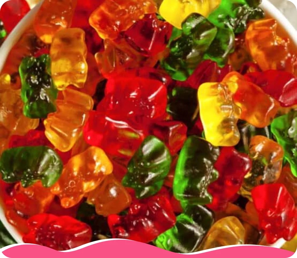 A close-up shot of a pile of colorful gummy bears in red, green, orange, and yellow.