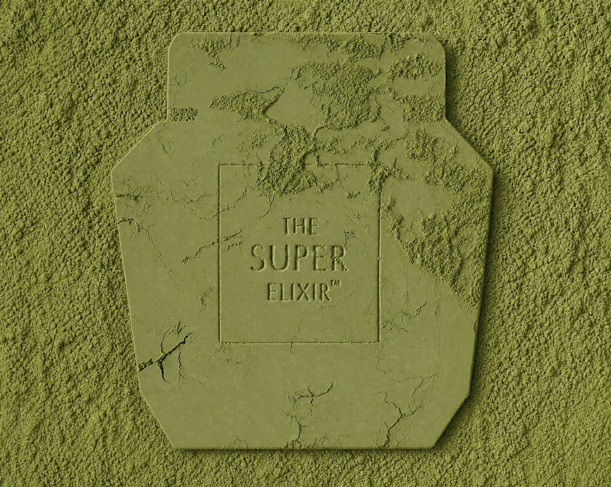 The Super Elixir logo embossed in a bed of cracking green powder, seen from above.