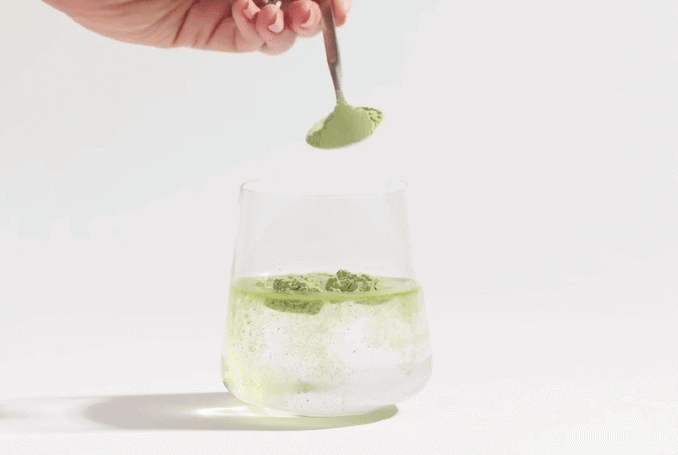 A glass of green juice with a text overlay showing a timeline of potential health benefits.