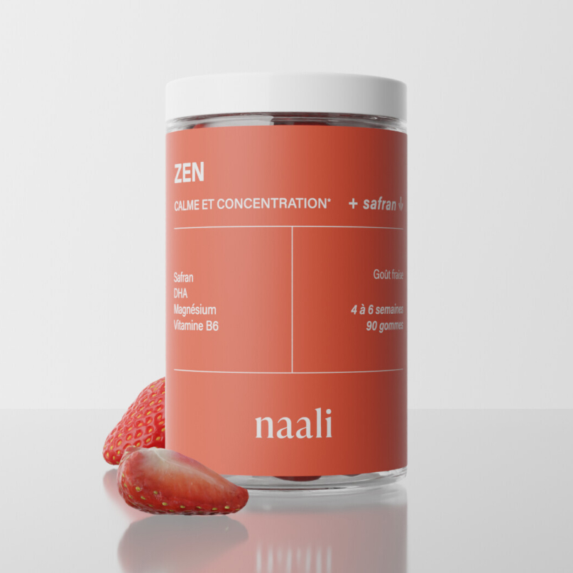 Jar labeled 'Zen' with strawberries beside it on a white background.