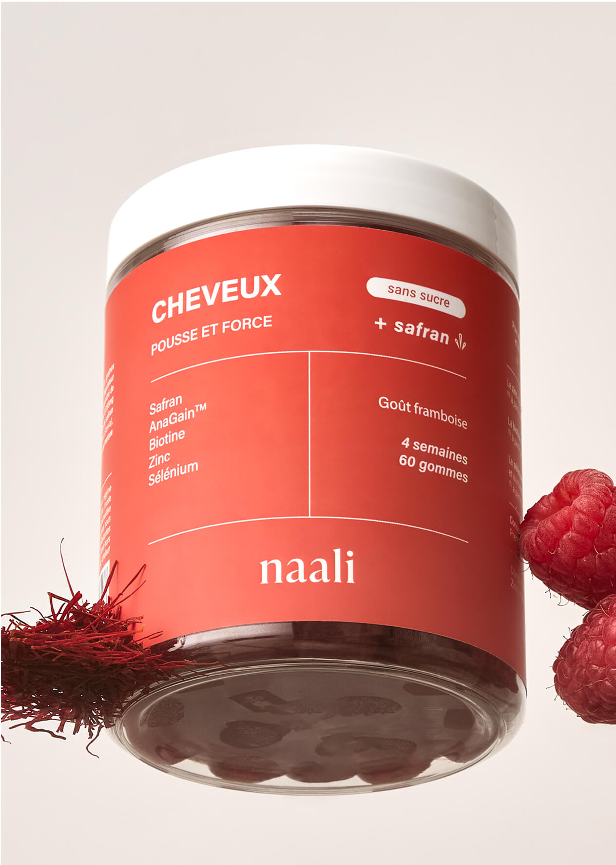Red jar labeled 'naali' with raspberries and saffron strands.