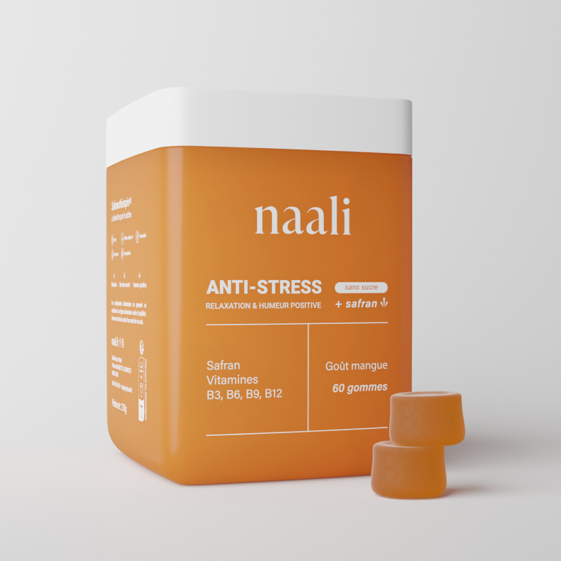 Orange container labeled 'naali' with anti-stress gummies, two gummies beside it.