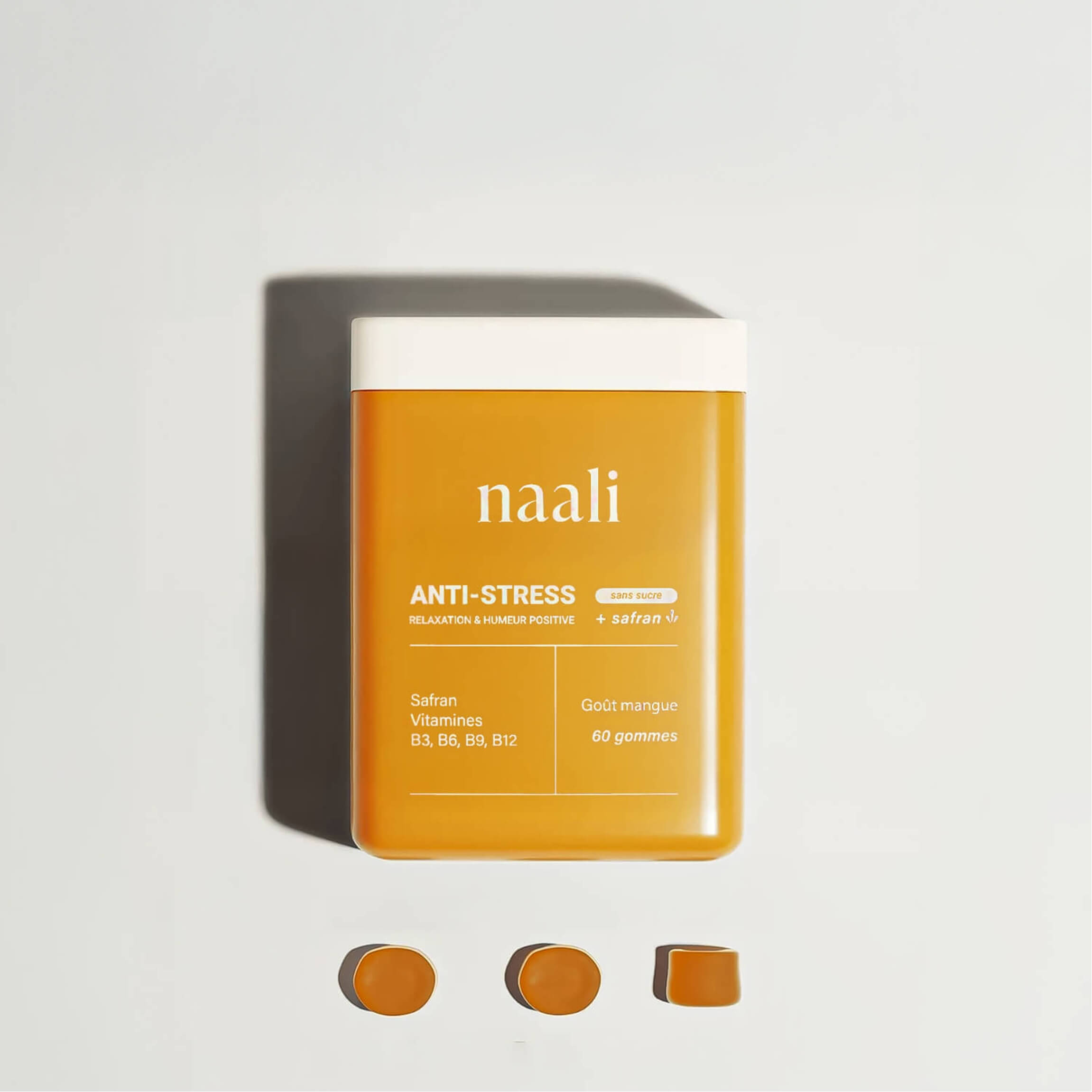 Orange container labeled 'naali Anti-Stress' with three gummies below.