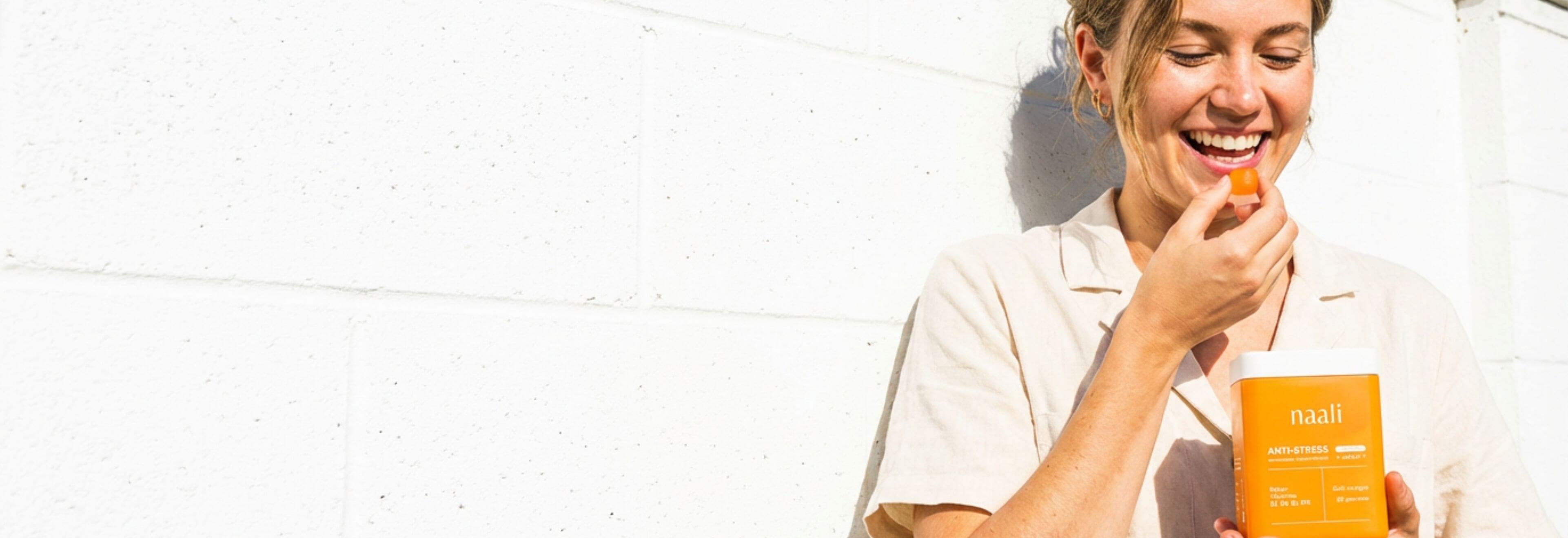 Three naali skincare products on a checkered background with orange accents.