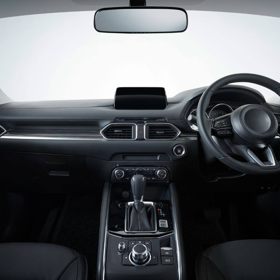 Interior view of a car dashboard and steering wheel.